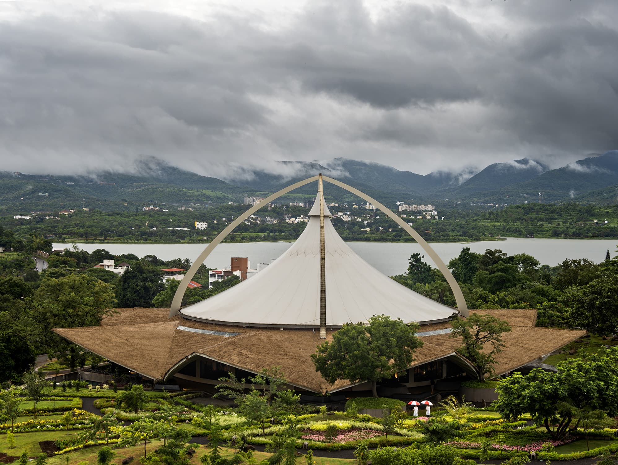 Dhyan Vihar near Mumbai, featuring a distinctive tent-like structure, nestled in greenery, ideal for yoga and meditation.