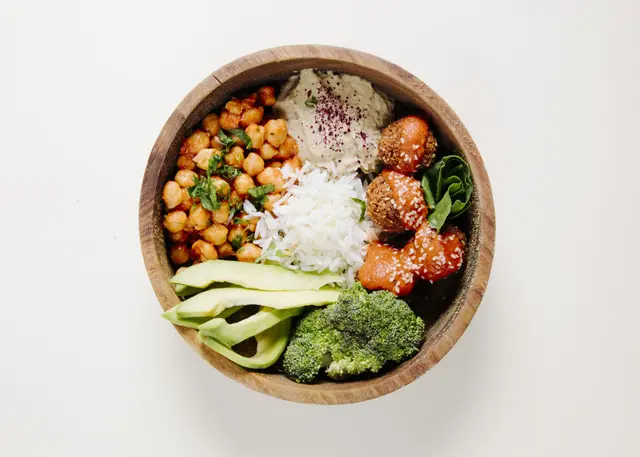 meatballs-rice-beans-broccoli-inside-wooden-bowl Bowl of wholesome, naturally sourced ingredients at SWASTIK, prioritizing health and nutrition with fresh, seasonal foods.