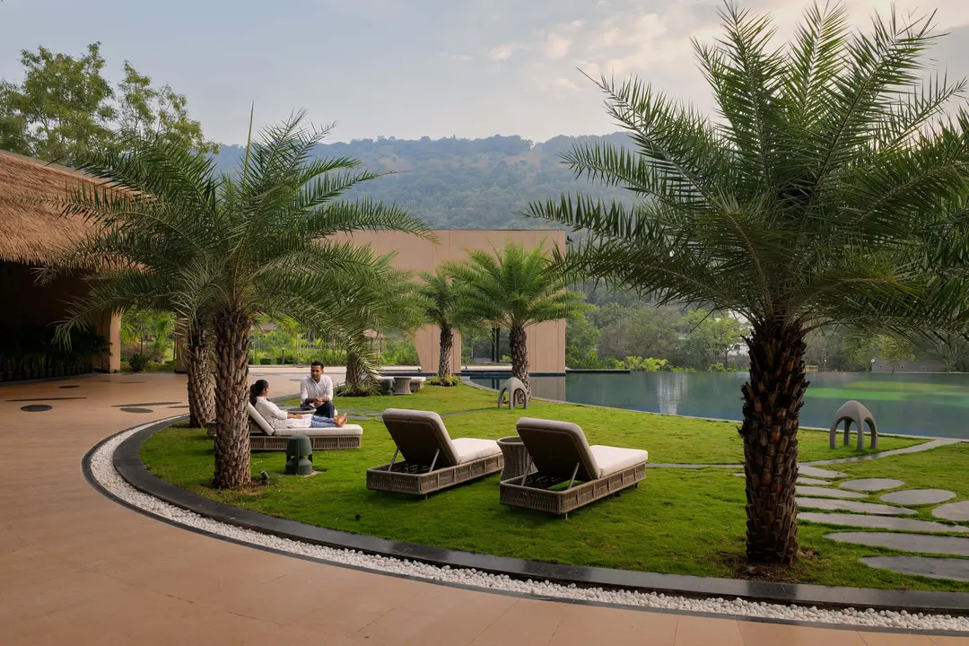 smitam Smitam poolside lounge at Swastik Anand Vihar, a serene retreat for holistic rejuvenation. Luxury Wellness Center