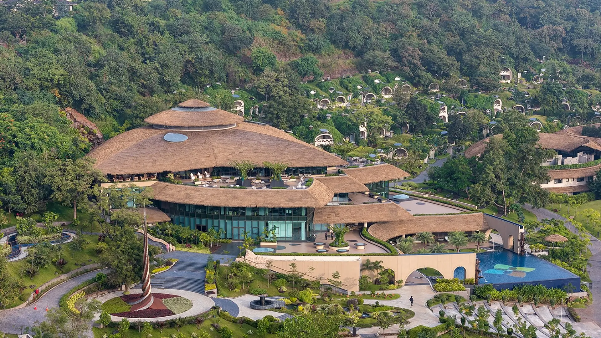 Anand Vihar's thatched-roof retreat with a pool and palm trees offers holistic healing and luxury wellness programs.