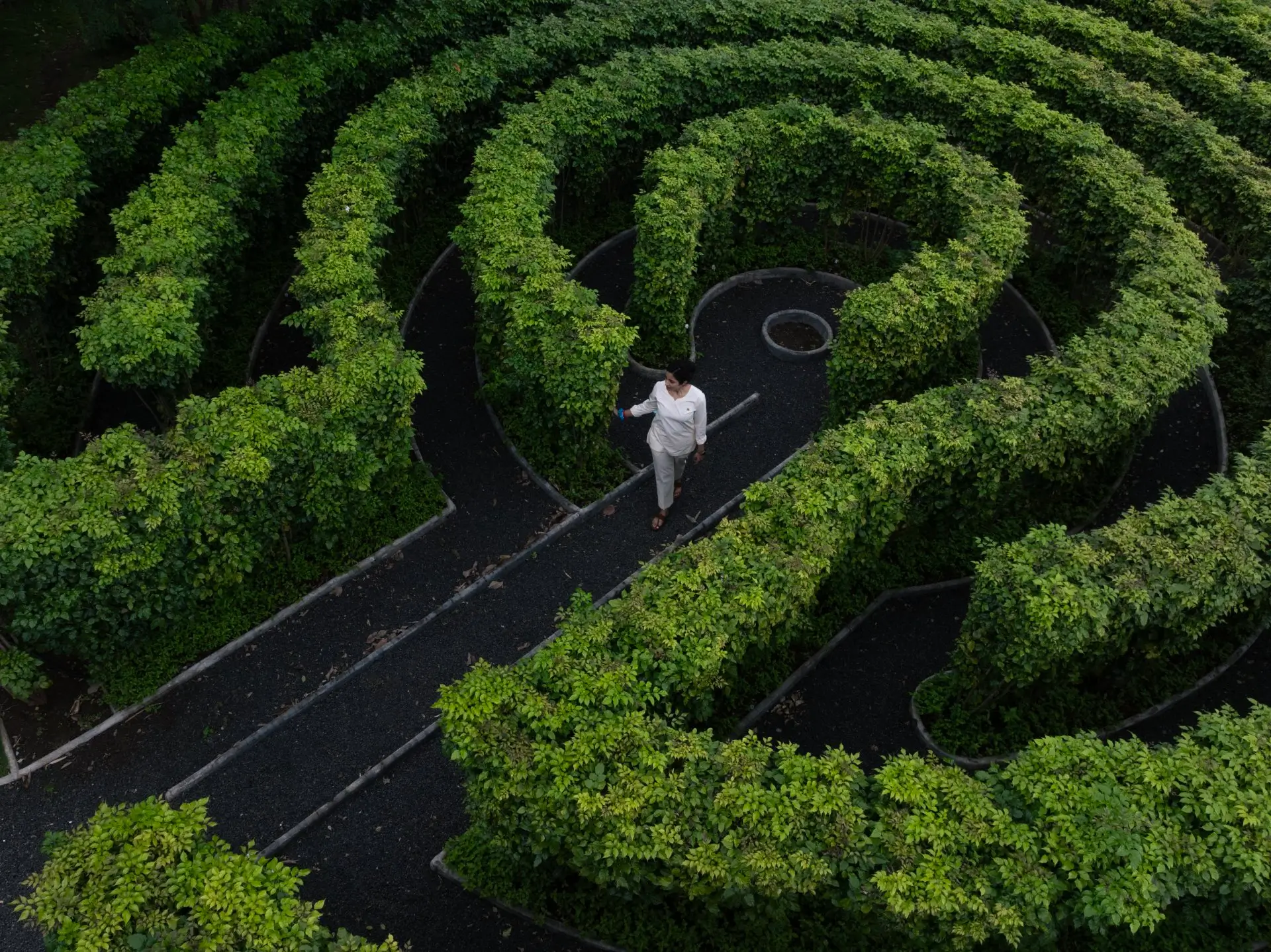 Bodhi Vihar Rake Garden at Swastik Ayu Vihar, featuring lush green labyrinth design for meditation and spiritual renewal.