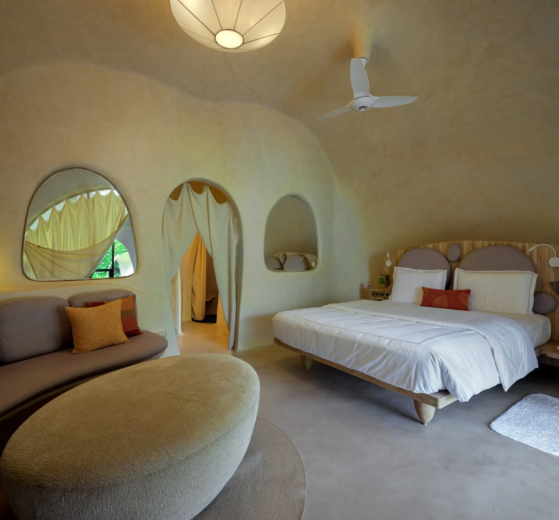 Aaram Guha suite at Sukh Vihar with a curved earthen bedroom and natural-light veranda