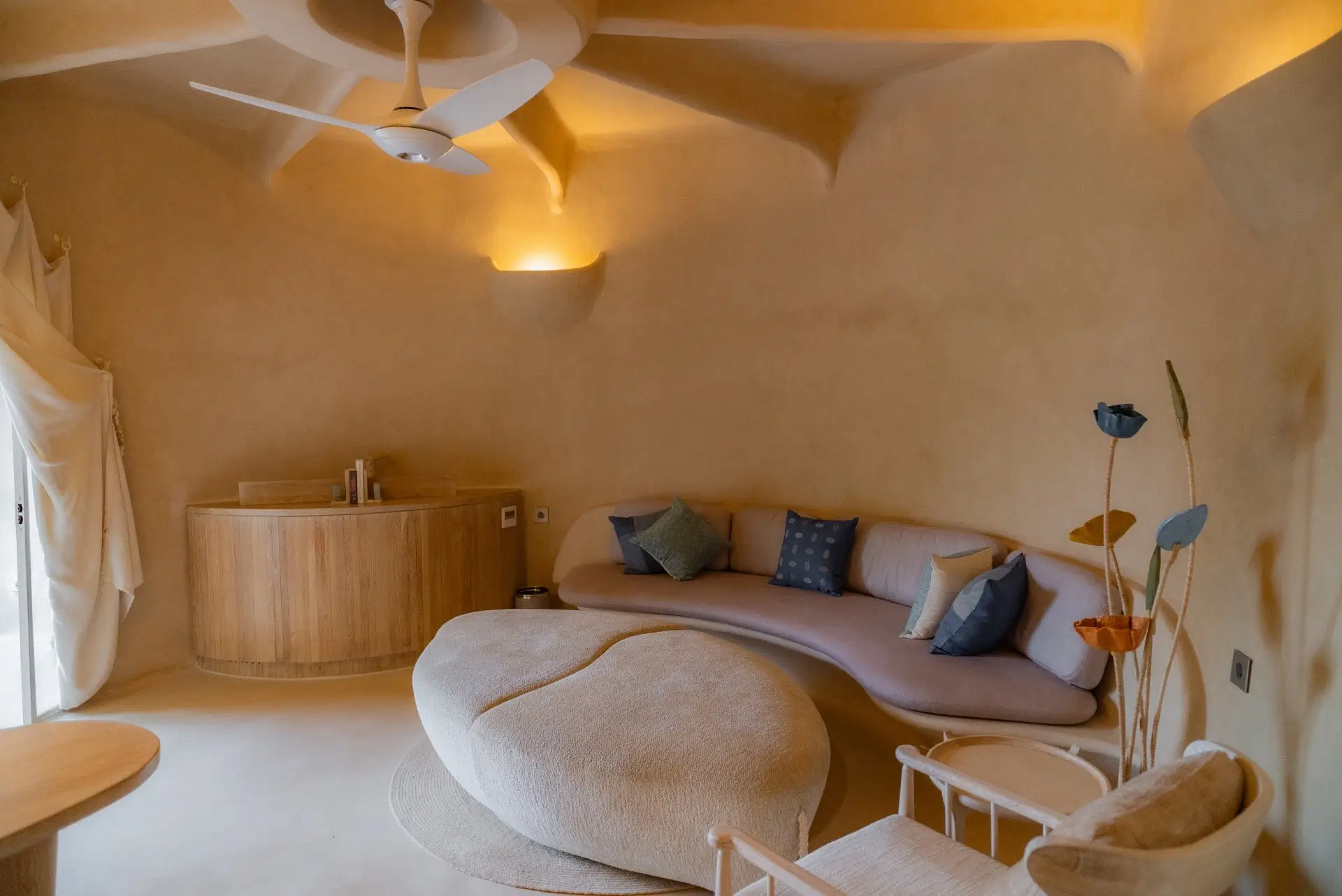 Maha Guha duplex suite at Sukh Vihar with a curved living room and earthy interiors