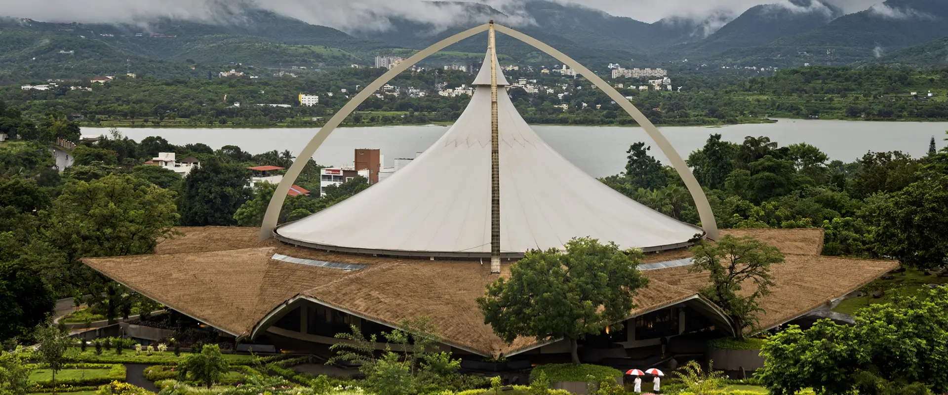 Monsoon Panchakarma retreat in India with tent roof under rain clouds and misty Western Ghats